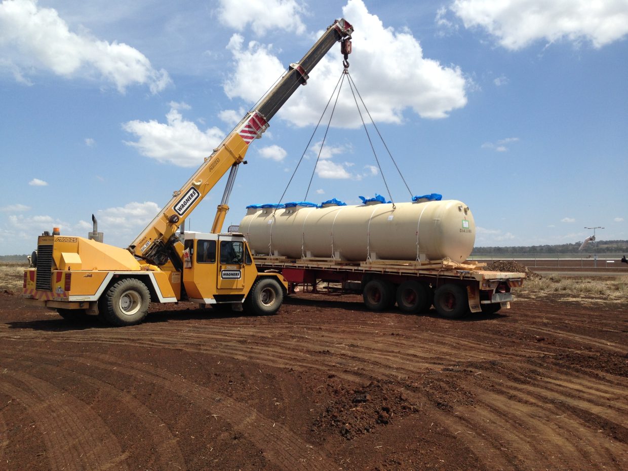 The modular sewage treatment plant being craned into position next to the airport runway.