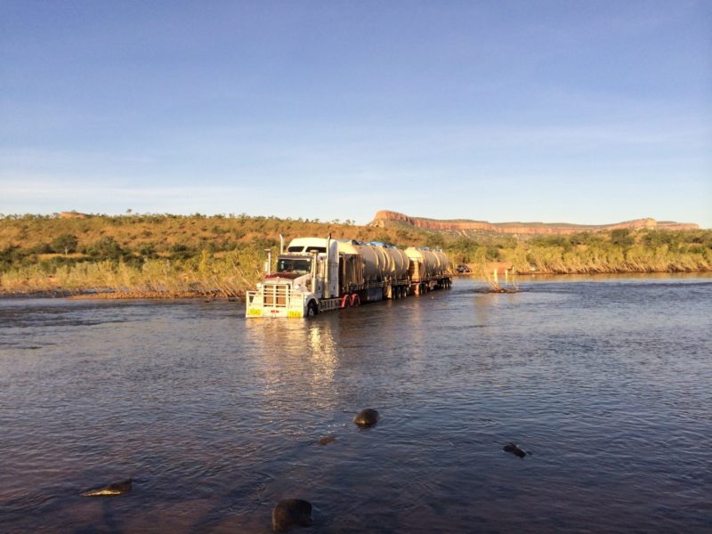 Truck crossing a river to deliver the STP to Home Valley Station