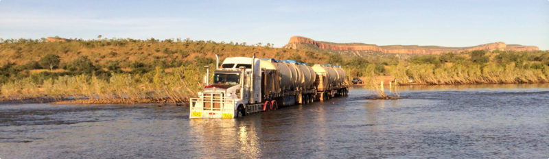 Truck crossing a river to deliver the STP to Home Valley Station