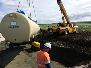 Hoisting a sizable tank with precision.